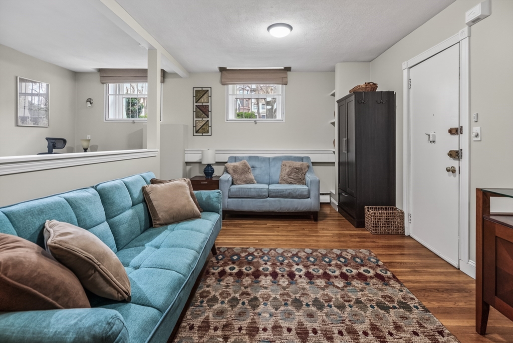 64 Commonwealth Avenue, Unit G1 Boston, MA 02116 - Photo 2 of 12 a living room with furniture and a rug