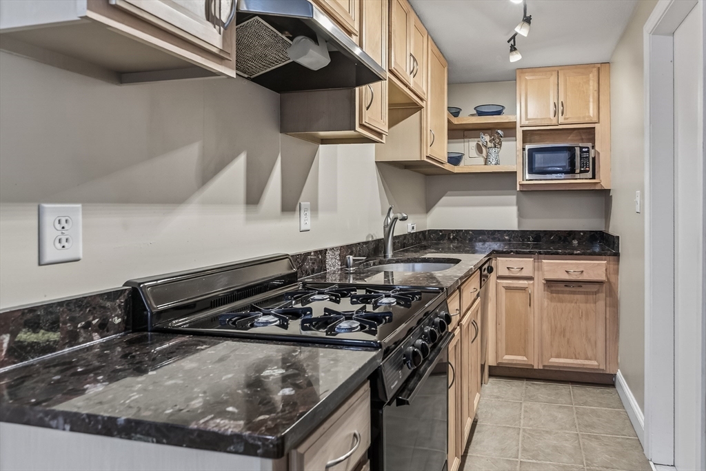 64 Commonwealth Avenue, Unit G1 Boston, MA 02116 - Photo 9 of 12 a kitchen with a stove and a refrigerator