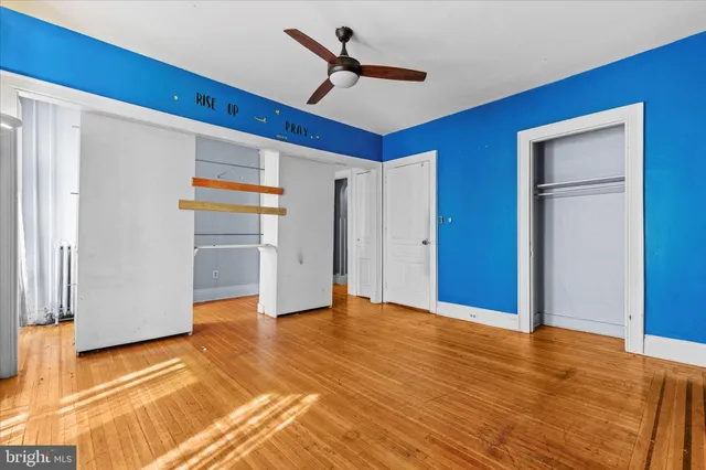 a view of empty room with wooden floor