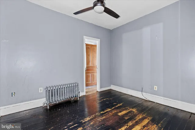 wooden floor in a hall with a window