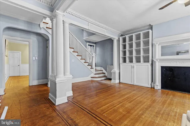 a view of entryway and hall with wooden floor