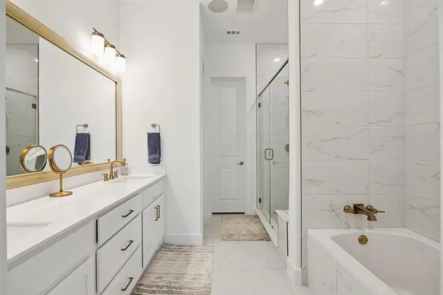 a bedroom with a bed couch and a large window