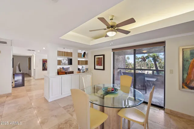 a living room with furniture a flat screen tv and a large window