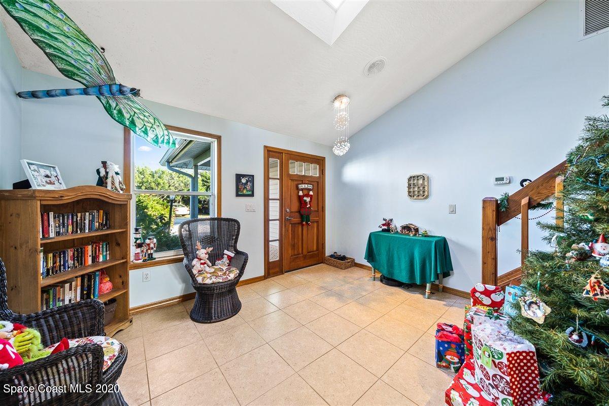 145 Richards Road Melbourne Beach, FL 32951 - Photo 14 of 53 a bedroom with furniture and a book shelf