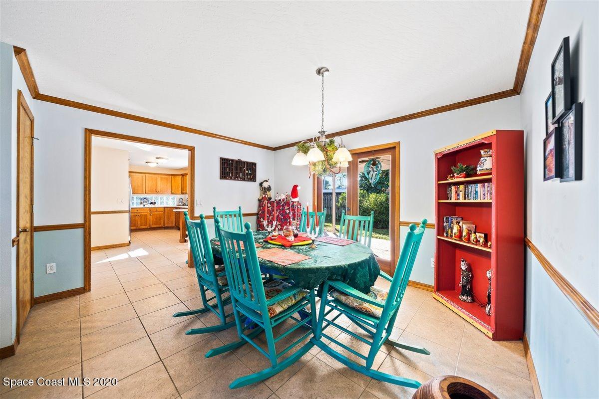 145 Richards Road Melbourne Beach, FL 32951 - Photo 17 of 53 a view of a dining room with furniture and a chandelier