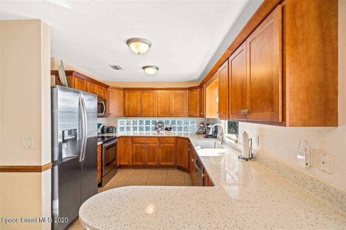 145 Richards Road Melbourne Beach, FL 32951 - Photo 22 of 53 a large kitchen with a large window and stainless steel appliances