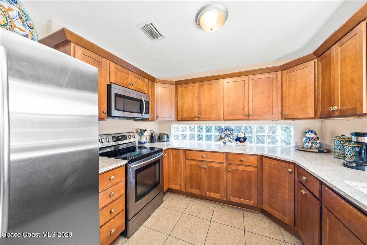145 Richards Road Melbourne Beach, FL 32951 - Photo 24 of 53 a kitchen with a sink stove top oven and cabinets