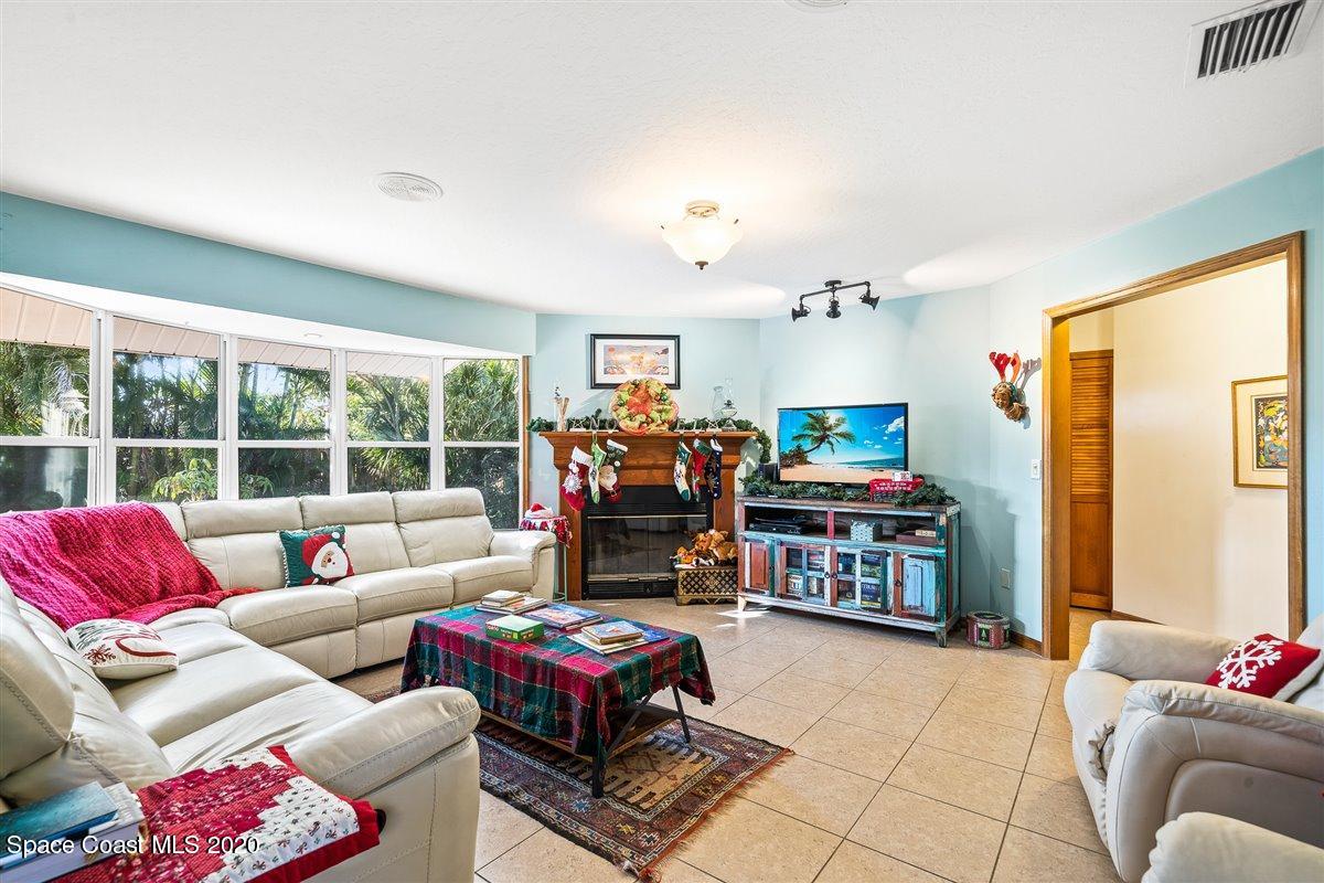 145 Richards Road Melbourne Beach, FL 32951 - Photo 27 of 53 a living room filled with furniture and a floor to ceiling window