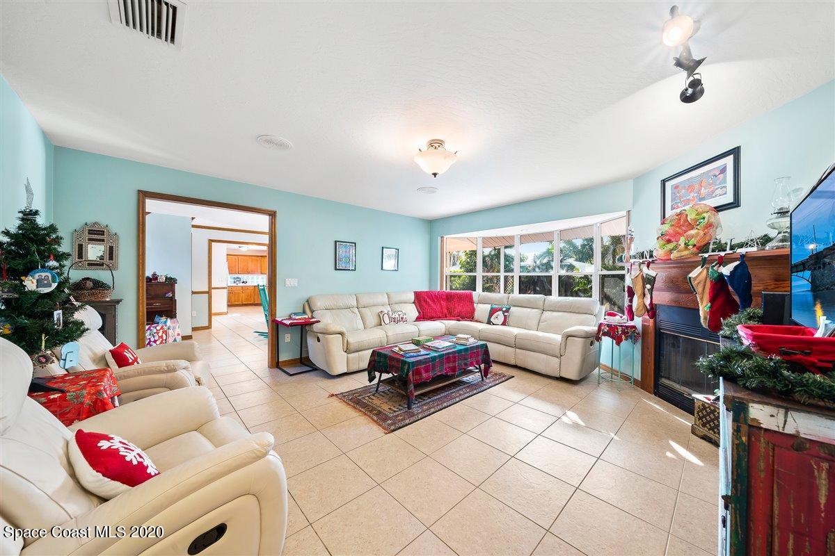 145 Richards Road Melbourne Beach, FL 32951 - Photo 29 of 53 a living room with furniture and a floor to ceiling window