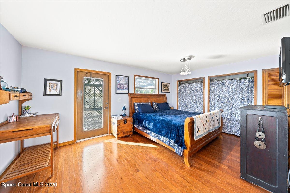 145 Richards Road Melbourne Beach, FL 32951 - Photo 32 of 53 a bedroom with a bed and a dresser with rug