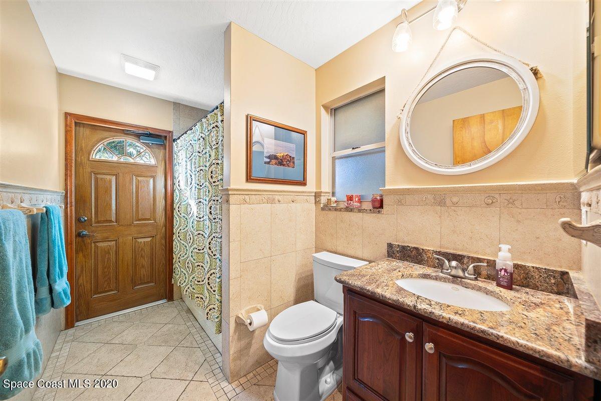 145 Richards Road Melbourne Beach, FL 32951 - Photo 42 of 53 a bathroom with a granite countertop toilet sink and mirror