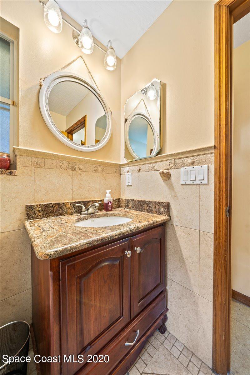 145 Richards Road Melbourne Beach, FL 32951 - Photo 44 of 53 a bathroom with a sink and a mirror