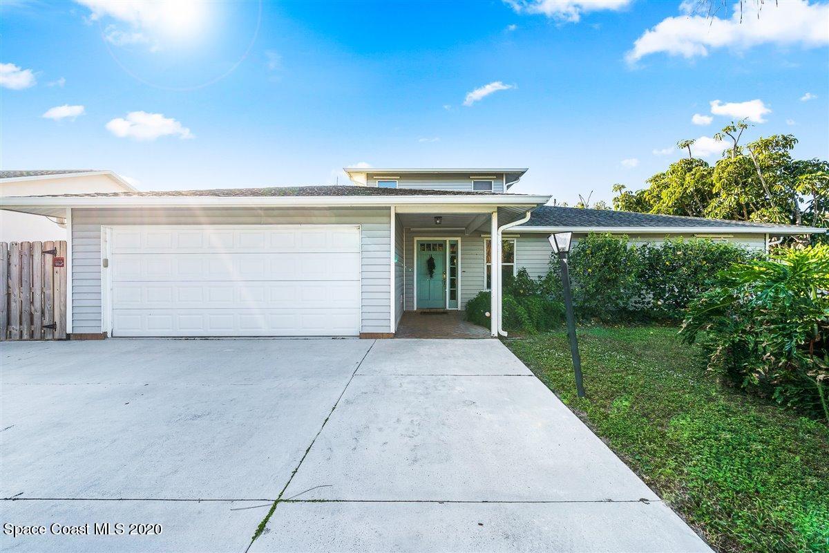 145 Richards Road Melbourne Beach, FL 32951 - Photo 10 of 53 a front view of a house with a yard and garage