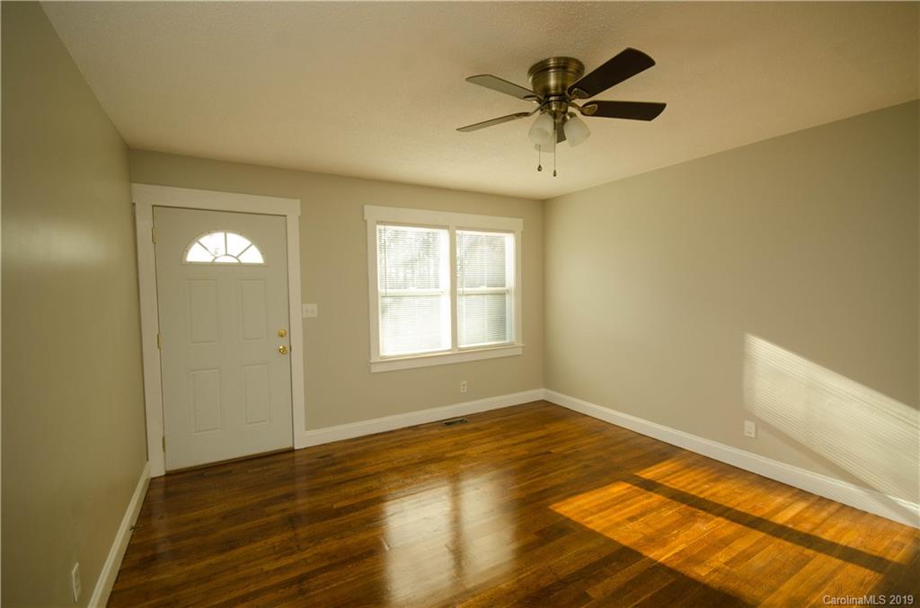 356 Old Pinckney Road York, SC 29745 - Photo 3 of 10 a view of empty room with wooden floor and fan