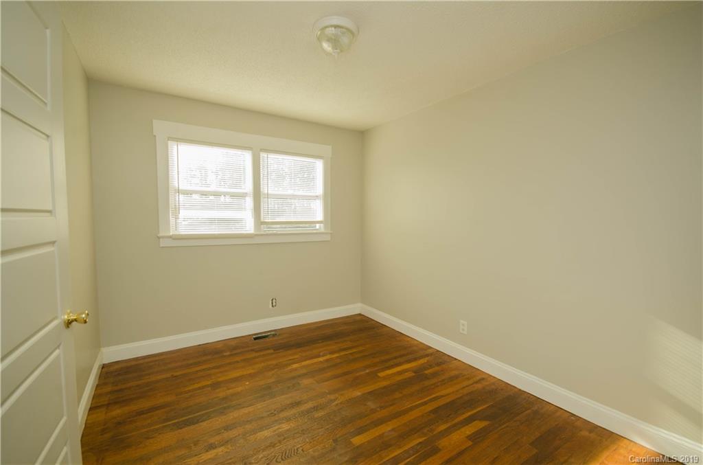 356 Old Pinckney Road York, SC 29745 - Photo 7 of 10 an empty room with wooden floor and windows