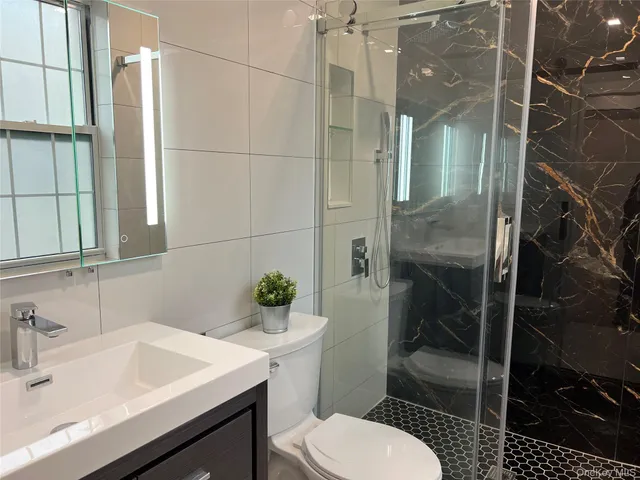 a bathroom with a sink toilet and shower