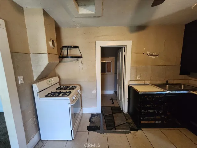 a kitchen with a stove and a refrigerator