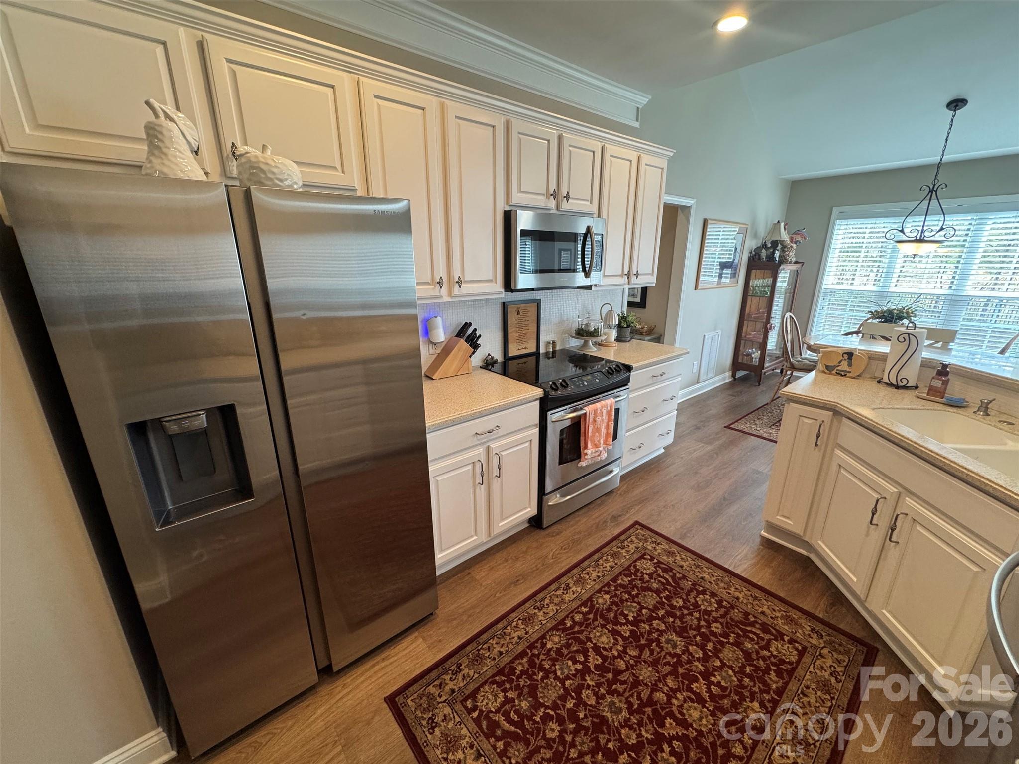 110 Burtons Barn Road Mooresville, NC 28115 - Photo 17 of 37 a kitchen with white cabinets and stainless steel appliances