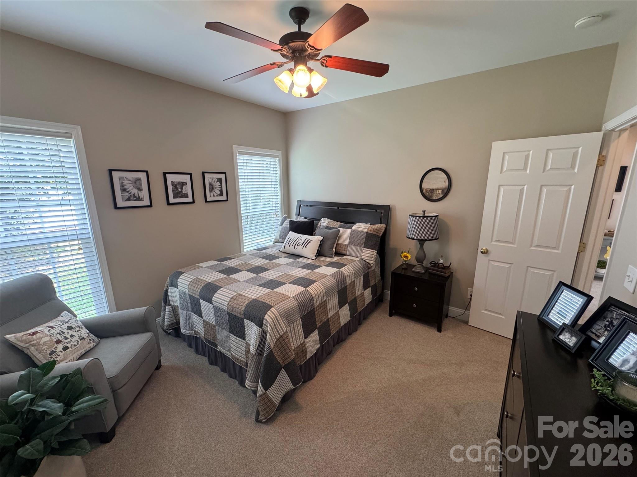 110 Burtons Barn Road Mooresville, NC 28115 - Photo 26 of 37 a bedroom with a bed and a chandelier