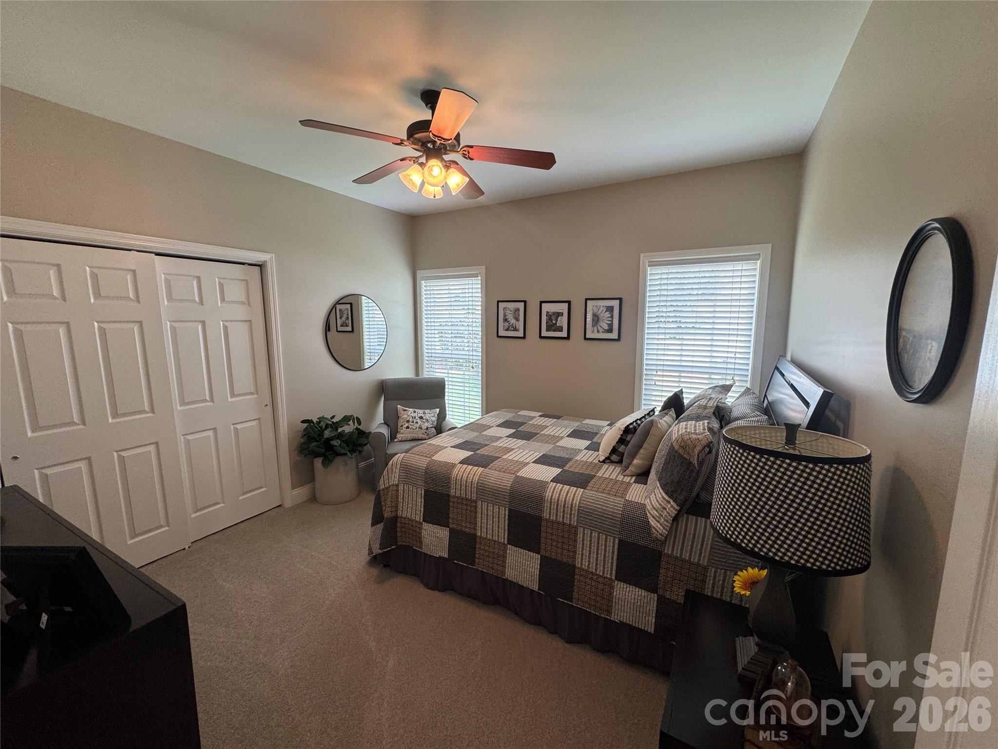 110 Burtons Barn Road Mooresville, NC 28115 - Photo 27 of 37 a bedroom with bed and a chandelier