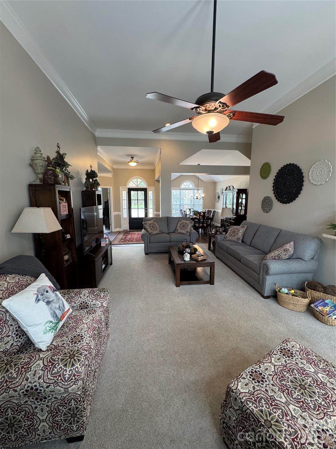 110 Burtons Barn Road Mooresville, NC 28115 - Photo 6 of 37 a living room with furniture a rug and a chandelier