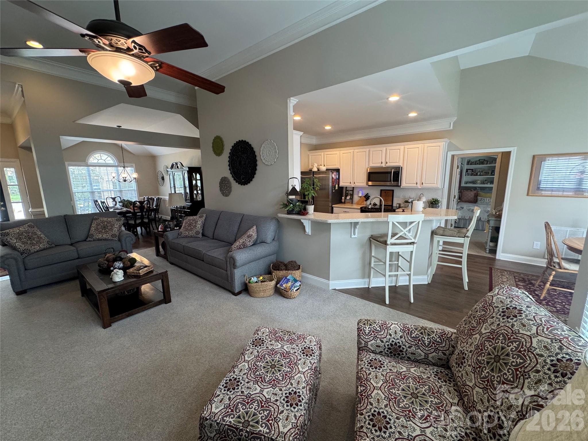 110 Burtons Barn Road Mooresville, NC 28115 - Photo 7 of 37 a living room with furniture a ceiling fan and a chandelier