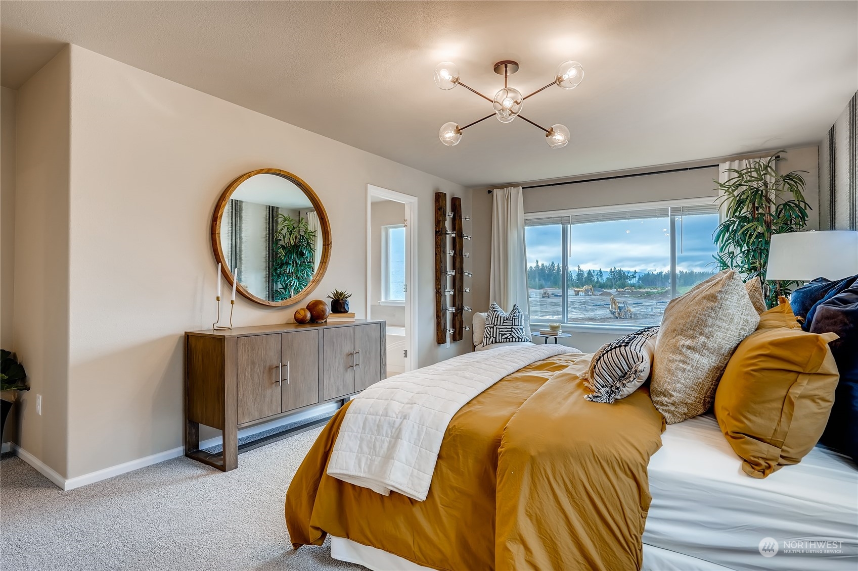 4131 235th Place Southeast, Unit 40 Bothell, WA 98021 - Photo 21 of 24 a bedroom with a bed a mirror on desk and a large window
