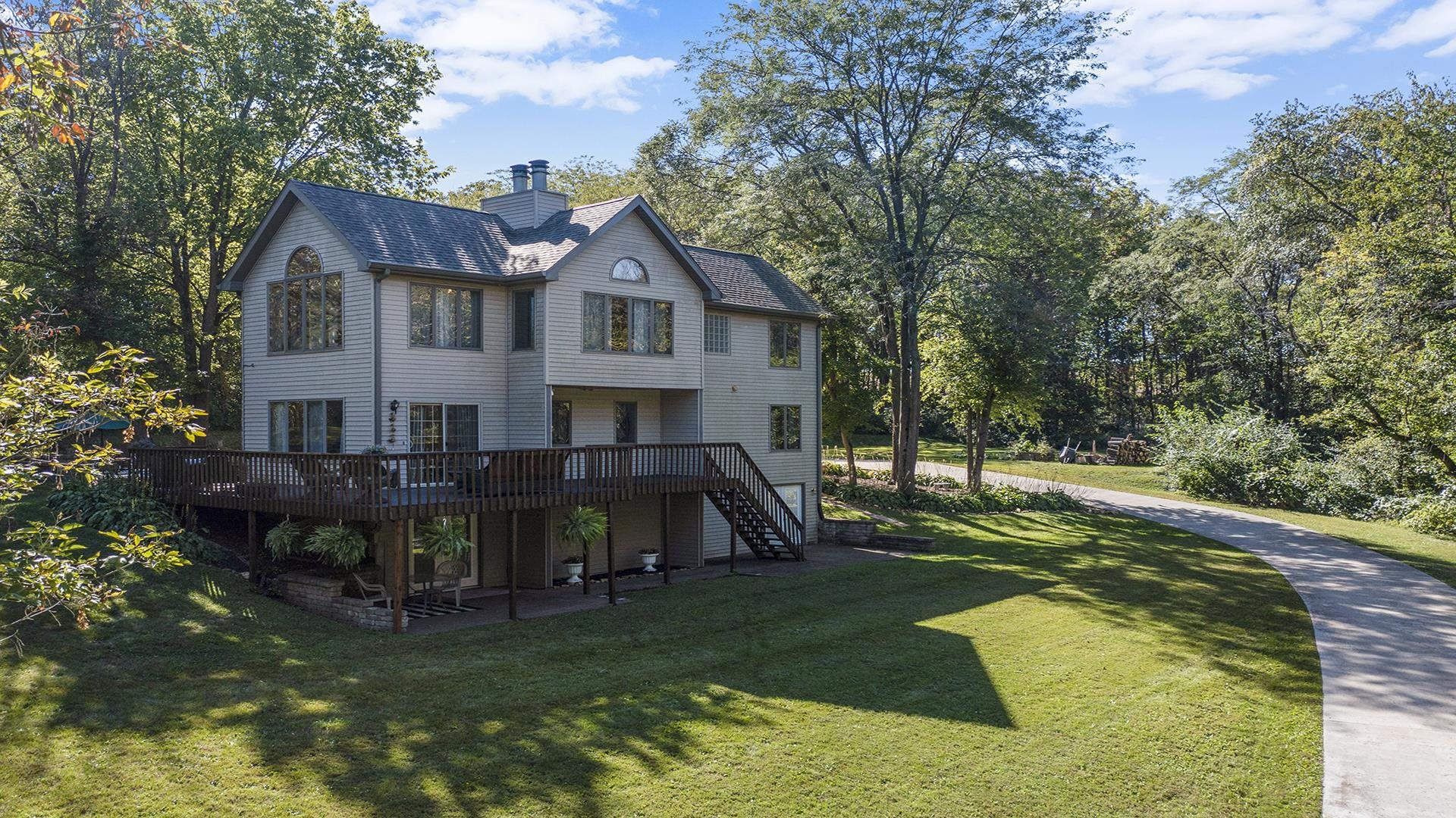a view of a house with backyard and sitting area
