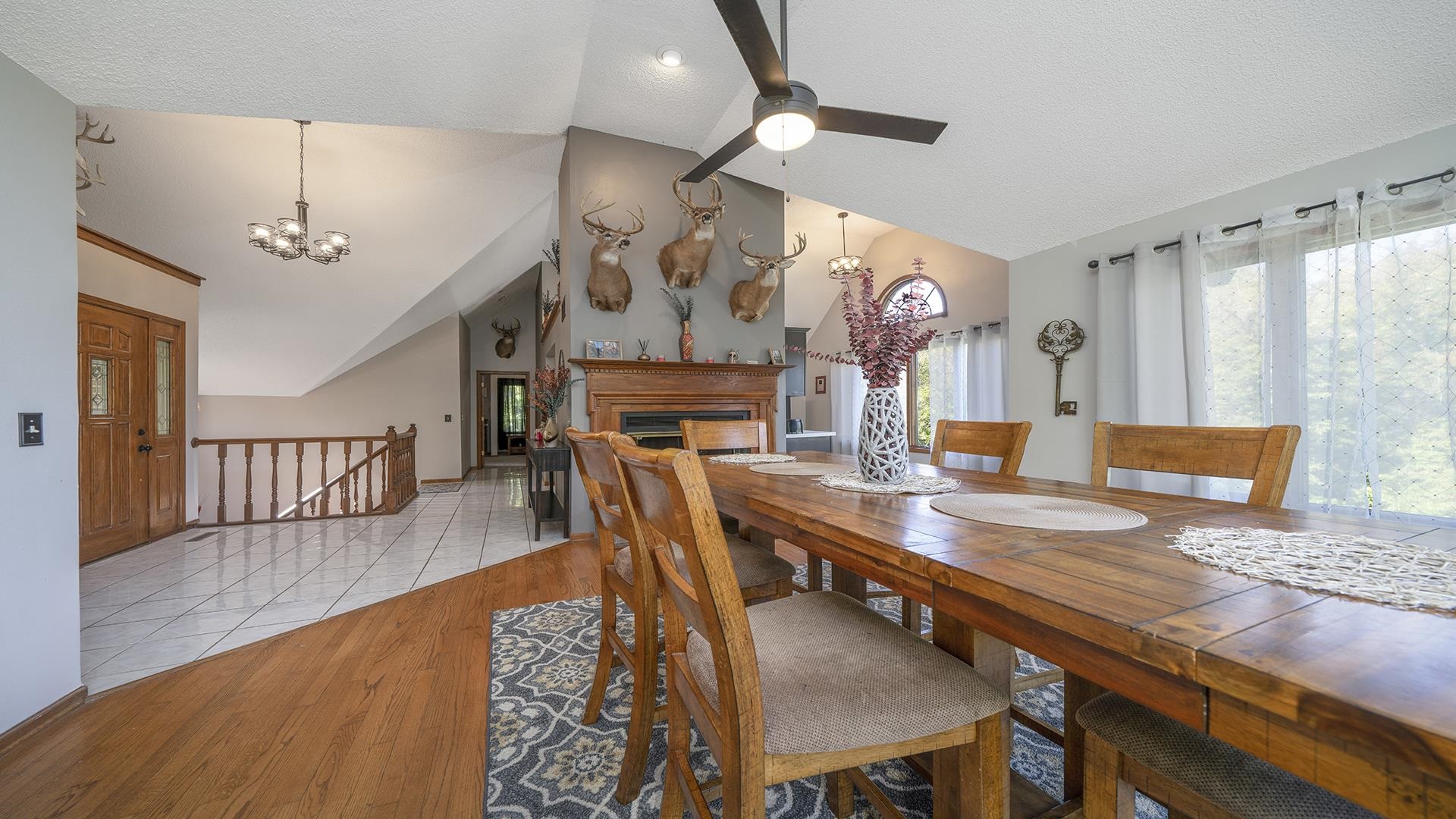 4432 Highway 2 Oregon, IL 61061 - Photo 26 of 49 a view of a dining room and livingroom with furniture wooden floor a rug a flat screen tv