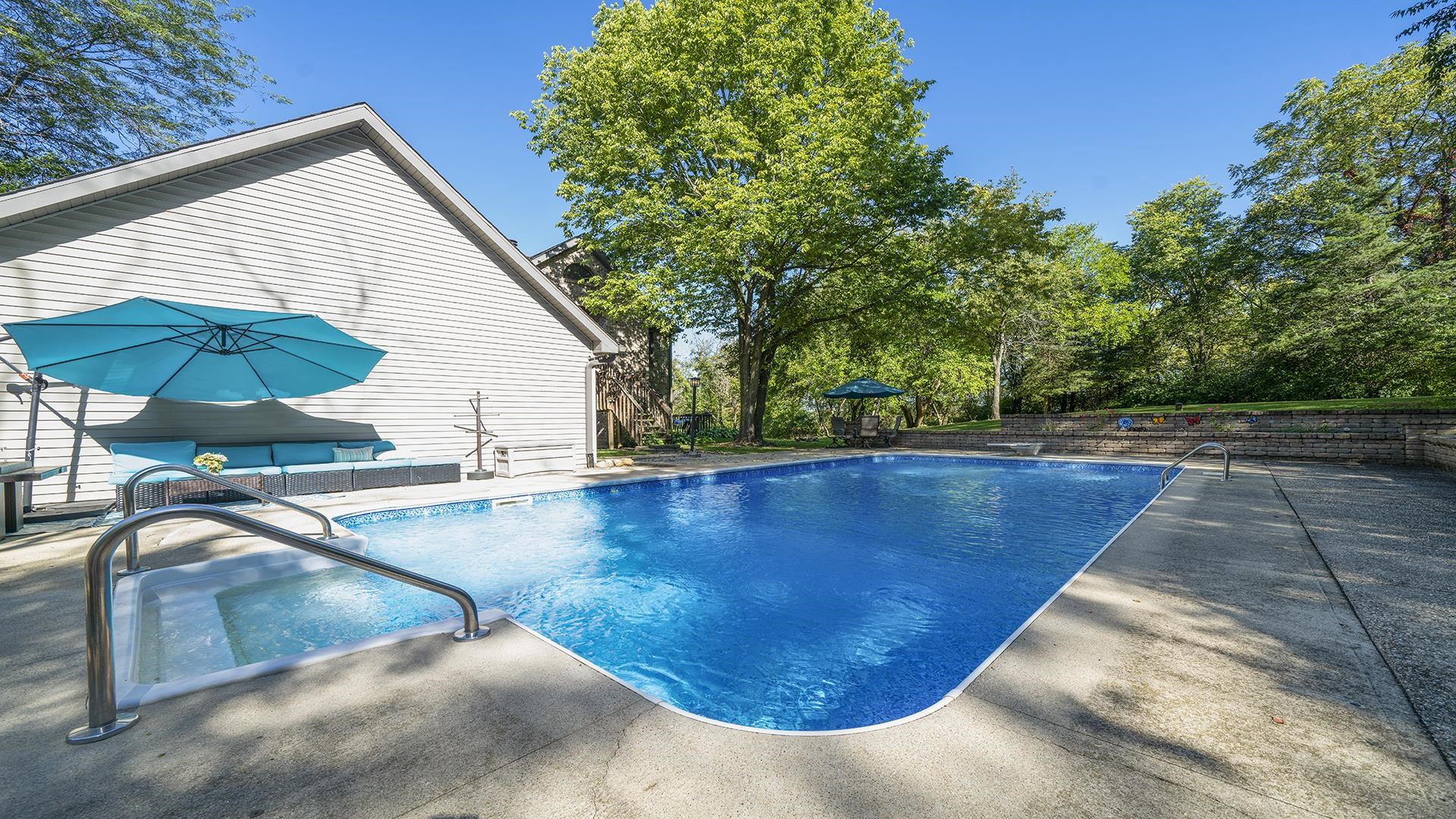 4432 Highway 2 Oregon, IL 61061 - Photo 7 of 49 a view of a swimming pool with a chair and tables