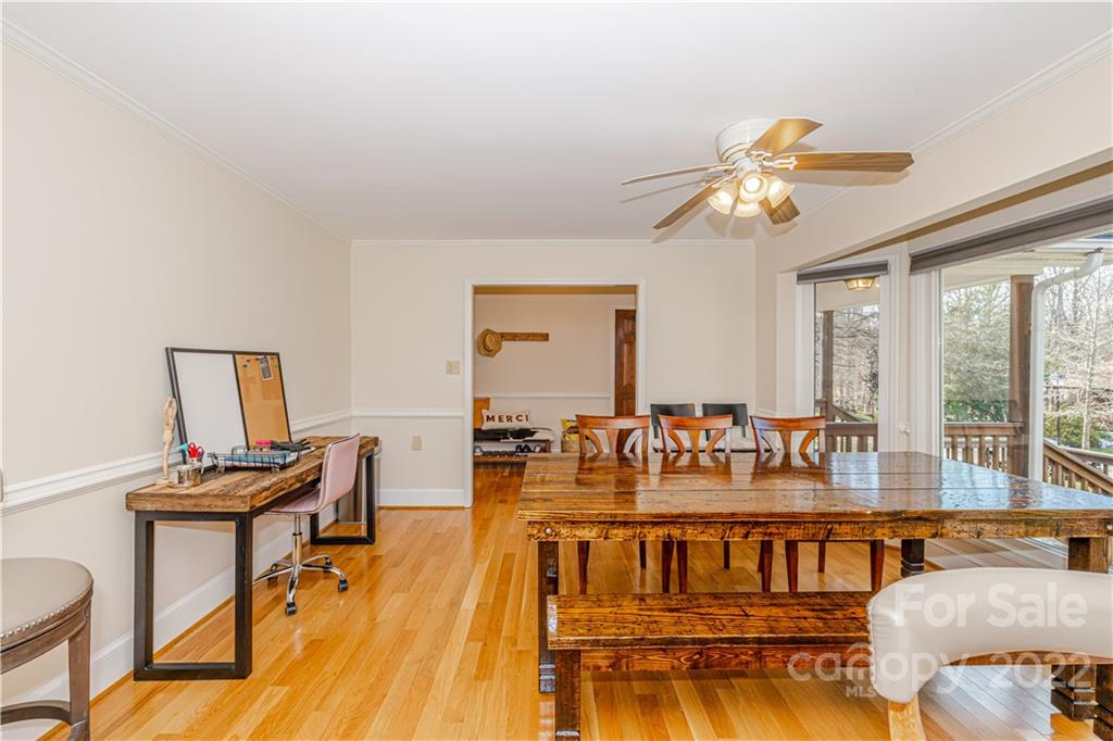 5100 Rounding Run Road Charlotte, NC 28277 - Photo 11 of 46 a view of a dining room with furniture a chandelier and wooden floor