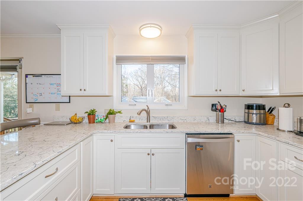 5100 Rounding Run Road Charlotte, NC 28277 - Photo 14 of 46 a kitchen with granite countertop a sink cabinets stainless steel appliances and a window