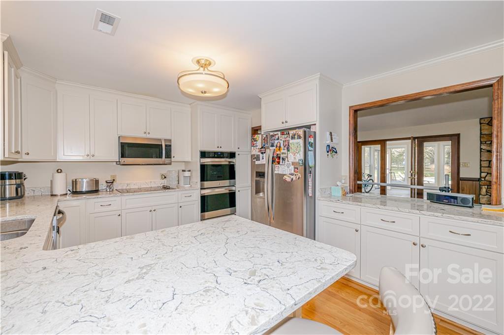 5100 Rounding Run Road Charlotte, NC 28277 - Photo 15 of 46 a kitchen with white cabinets and stainless steel appliances