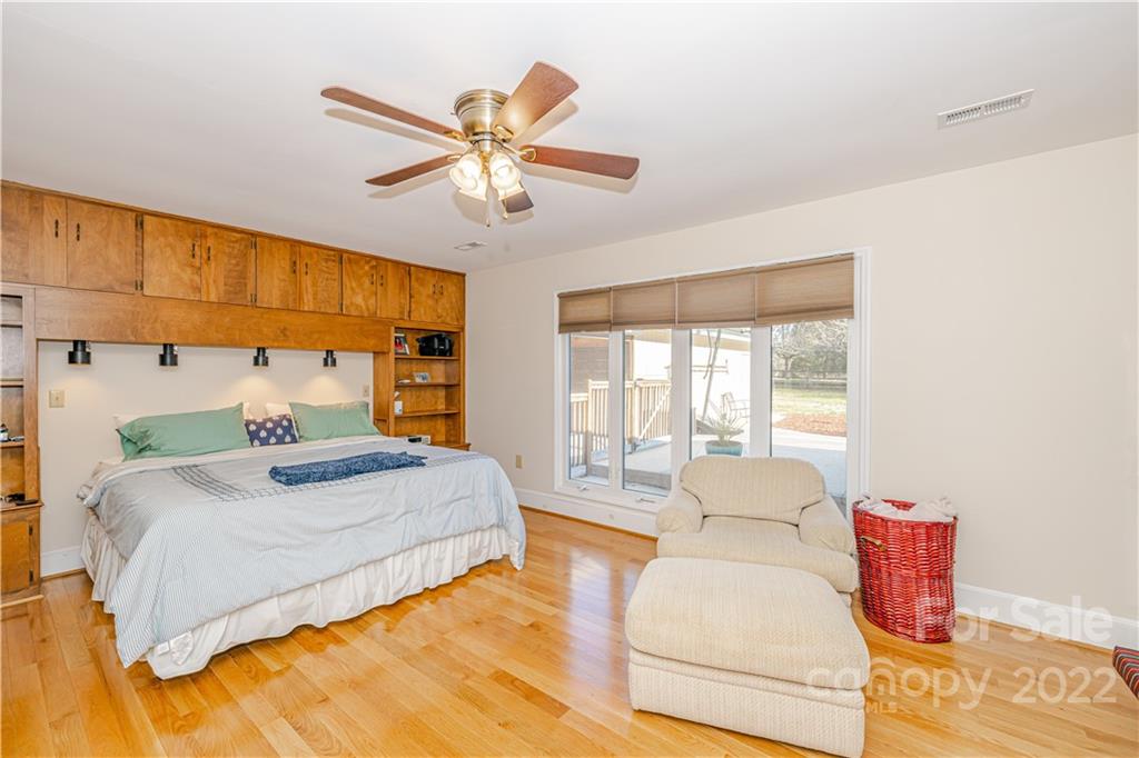 5100 Rounding Run Road Charlotte, NC 28277 - Photo 18 of 46 a bedroom with a large bed and a chandelier