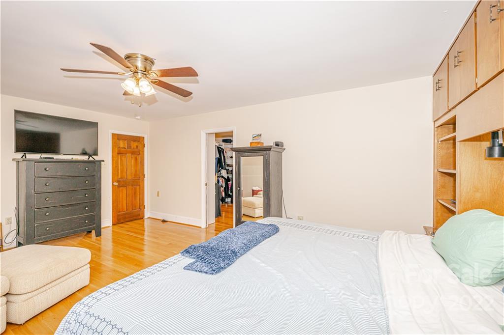 5100 Rounding Run Road Charlotte, NC 28277 - Photo 20 of 46 a bedroom with a bed and a chandelier