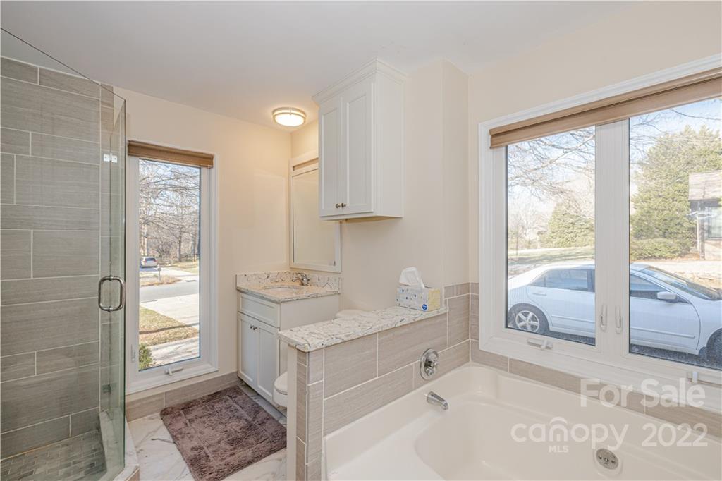 5100 Rounding Run Road Charlotte, NC 28277 - Photo 25 of 46 a bathroom with a double vanity sink a mirror and a bathtub