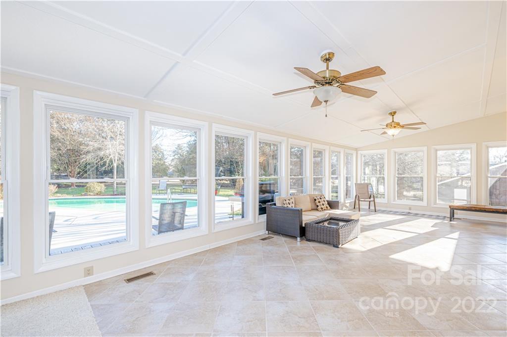 5100 Rounding Run Road Charlotte, NC 28277 - Photo 37 of 46 a living room with furniture large windows and a chandelier