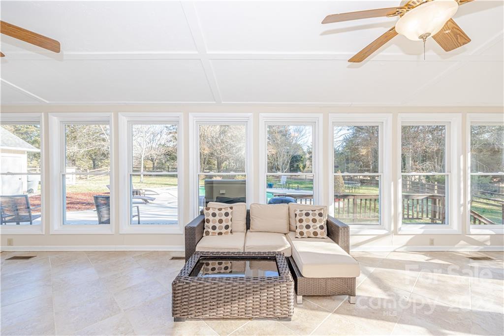 5100 Rounding Run Road Charlotte, NC 28277 - Photo 38 of 46 a living room with furniture and a floor to ceiling windows