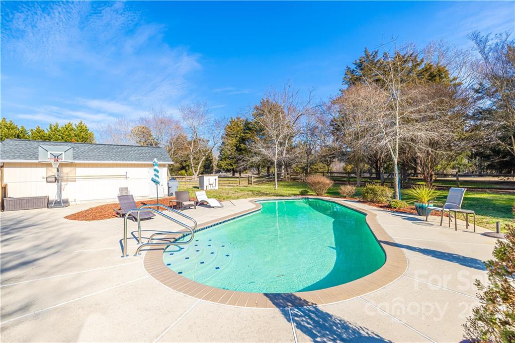 5100 Rounding Run Road Charlotte, NC 28277 - Photo 44 of 46 a view of a swimming pool with an outdoor seating and a yard