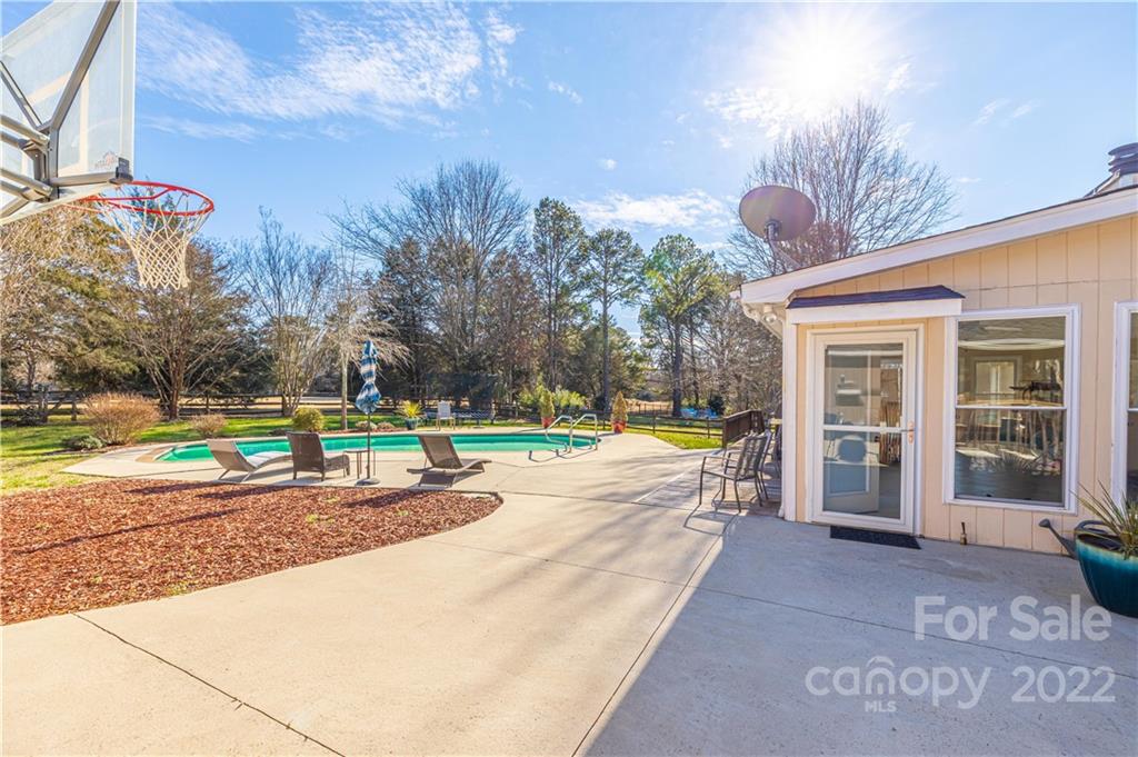 5100 Rounding Run Road Charlotte, NC 28277 - Photo 45 of 46 a view of a house with a swimming pool and a yard