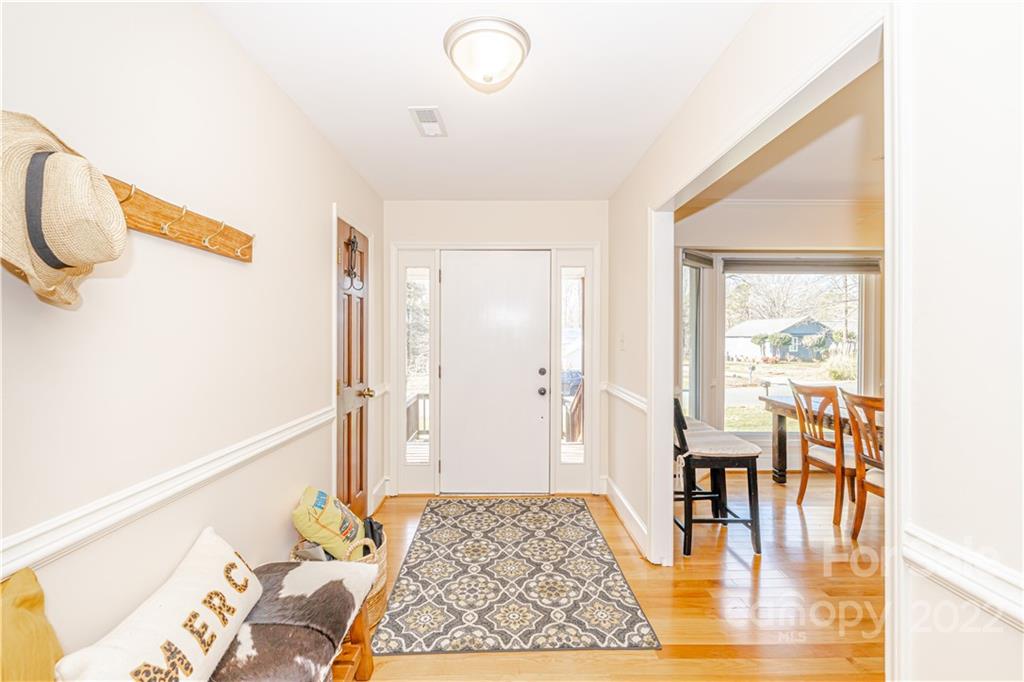 5100 Rounding Run Road Charlotte, NC 28277 - Photo 5 of 46 a view of a living room and a dining room with wooden floor