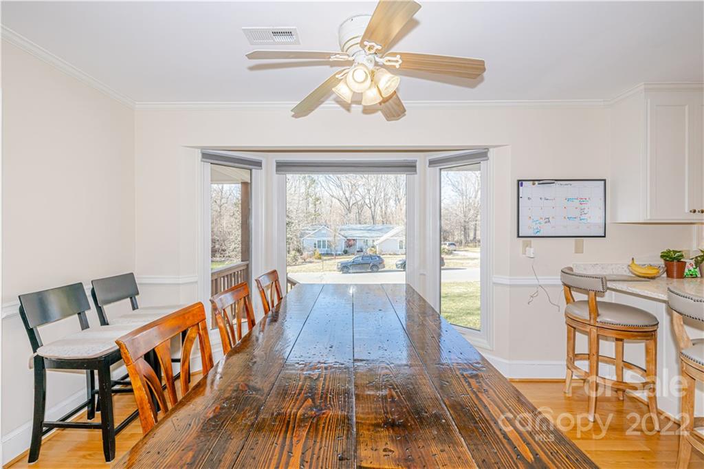 5100 Rounding Run Road Charlotte, NC 28277 - Photo 10 of 46 a view of a dining room with furniture a chandelier and wooden floor