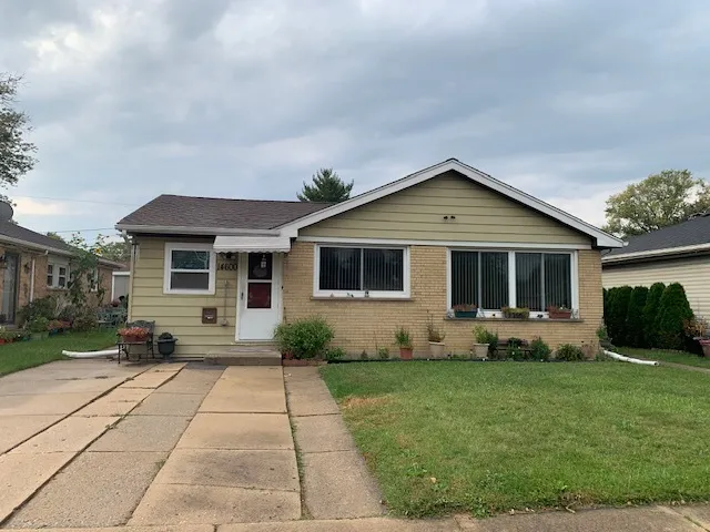 a front view of a house with a yard and outdoor seating