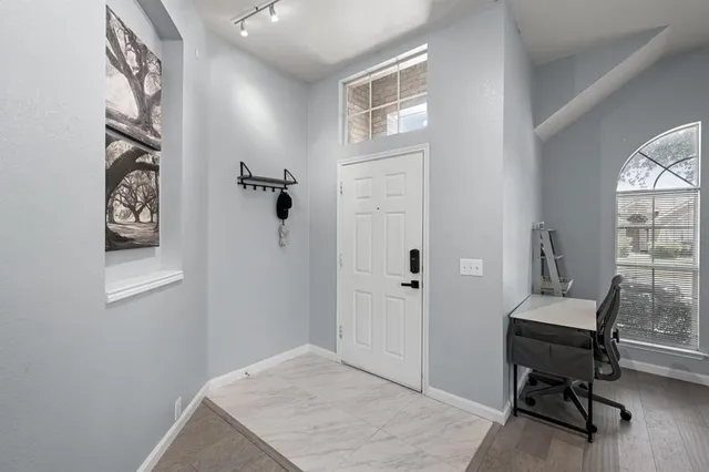a view of a workspace with furniture and a window
