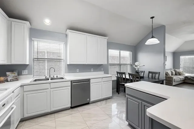 a kitchen with a sink stove and cabinets