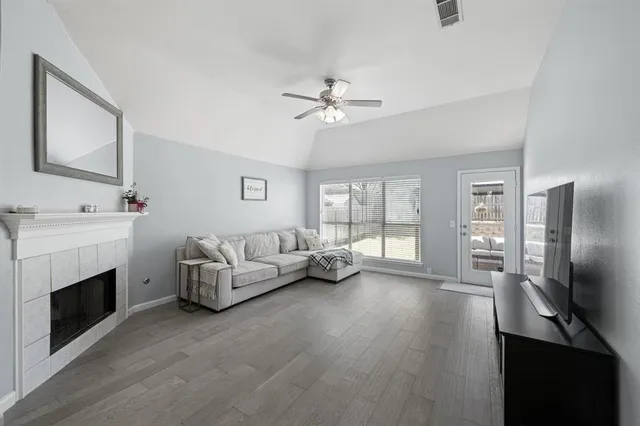 a living room with furniture a fireplace and a flat screen tv