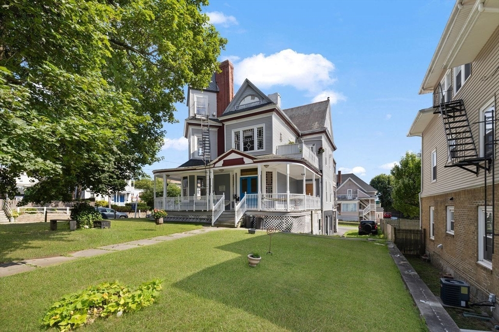 311 Elm Street Woonsocket, RI 02895 - Photo 1 of 29 a front view of a house with a yard