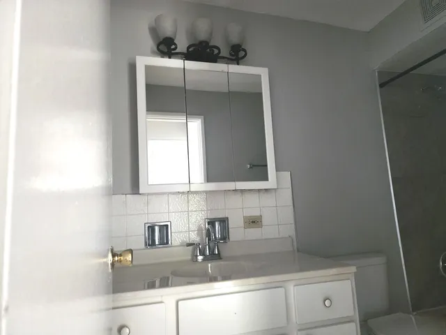 a kitchen with a stove a refrigerator and cabinets