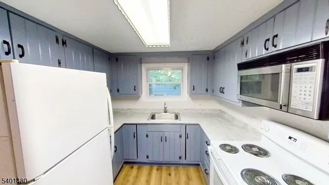 a kitchen with a refrigerator and a stove