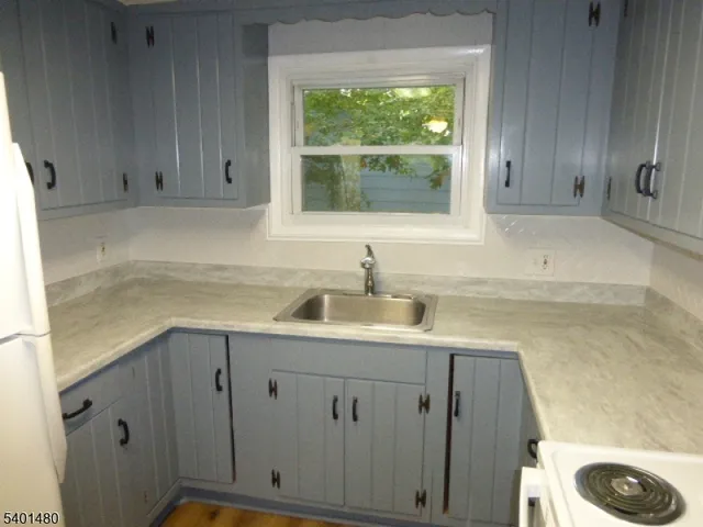 a kitchen with a sink cabinets and window